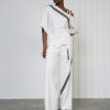 look sofisticat cu set ecru din bluză asimetrică pe un umăr și pantaloni largi